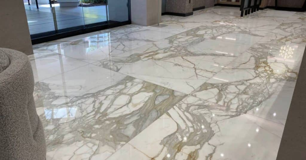 Marble tile polish service showcasing restored shine and natural veining in South Florida building lobby