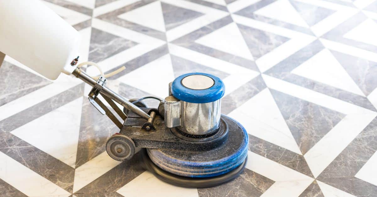 Professional floor polishing machine restoring shine to patterned marble flooring