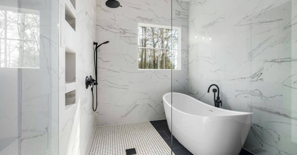 Modern kitchen with marble island, marble backsplash, and stainless steel appliances